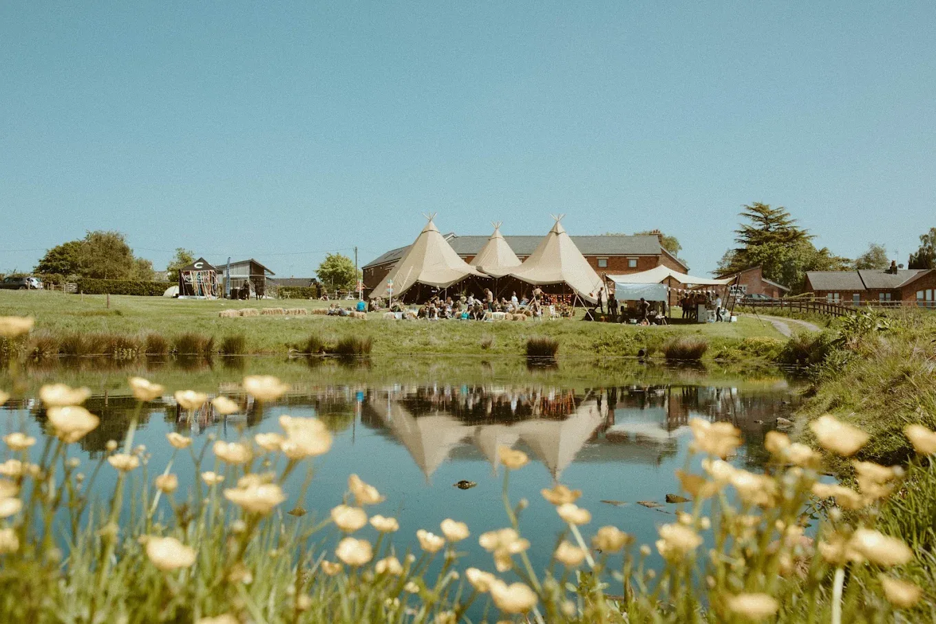 Tipis beside the lake at The Farm Club, Knutsford