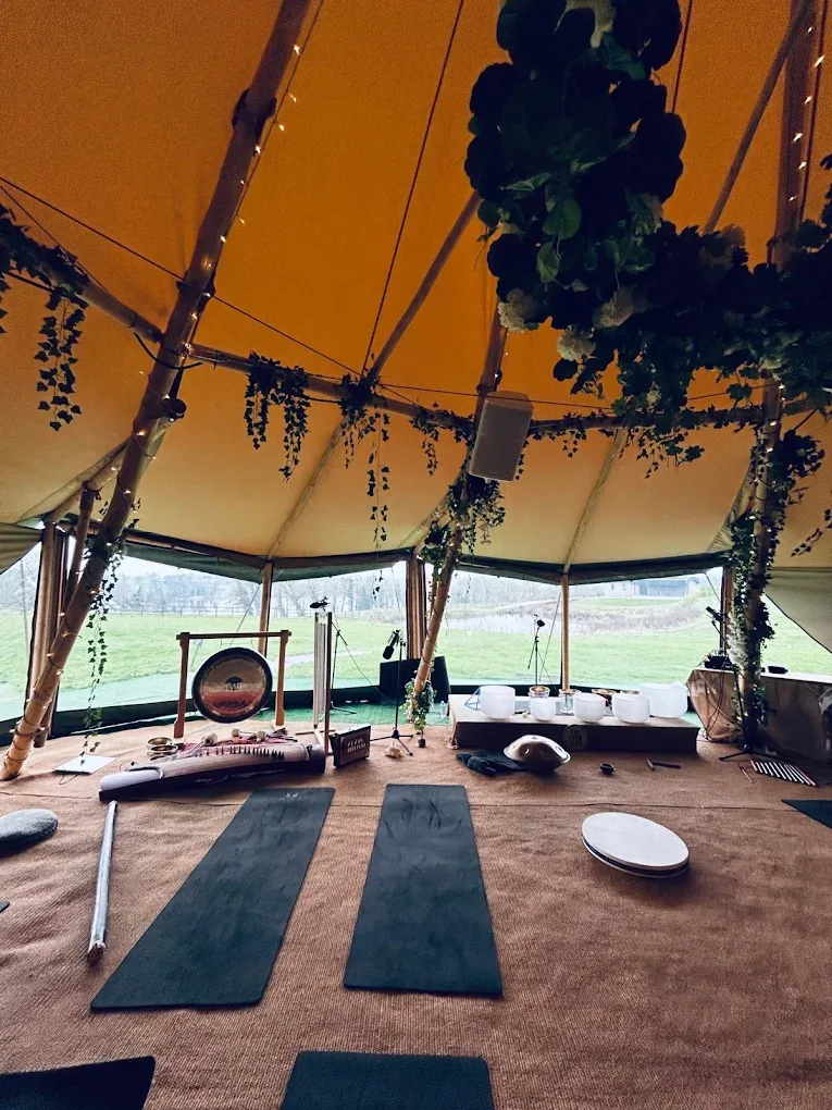 Mats, gongs and singing bowls laid out inside the tipi